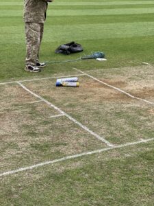 Grounds keeper marking the pitch at Doncaster town cricket club